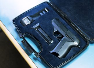 Researcher hacking, unlocking a smart gun with $15 magnets