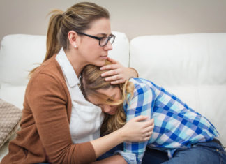 The age at which young women experience their first menstrual bleeding is linked to the age at which their sons start puberty